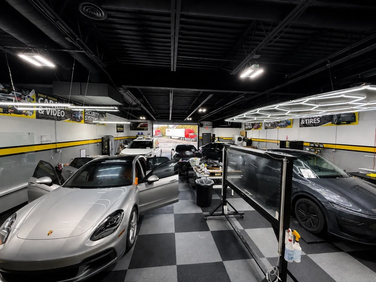 Inside Tint World Columbus: a Porsche Panamera in the install bay, photographed by WIT for the shop’s social content
